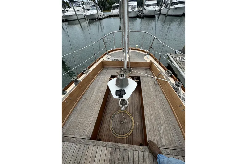 Slide: The Image of 1960 Alden Challenger 38 sailboat deck with wooden finish, docked at marina. - 7