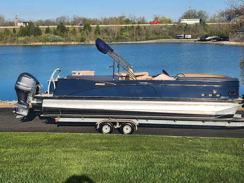 The Image of 2021 Avalon Catalina Platinum Entertainer Funship boat on trailer by a lake. - 0