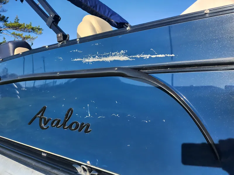 Slide: The Image of 2021 Avalon Catalina Platinum Entertainer Funship boat with visible scratches on the side. - 11