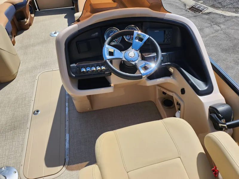 Slide: The Image of 2021 Avalon Catalina Platinum Entertainer Funship boat interior with steering wheel and dashboard. - 25