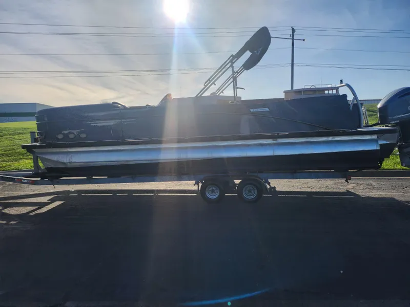 Slide: The Image of 2021 Avalon Catalina Platinum Entertainer Funship pontoon boat on trailer, sunlit background. - 4