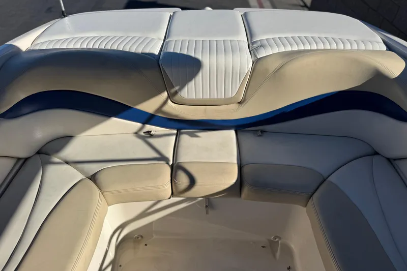 Slide: The Image of 2004 Glastron GX 235 boat interior with beige and white cushioned seating. - 13