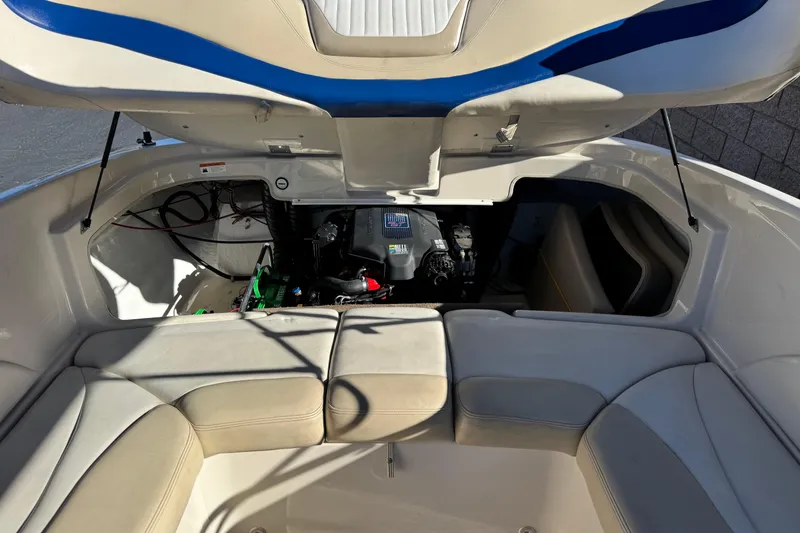 Slide: The Image of 2004 Glastron GX 235 boat engine compartment with open seating area. - 14