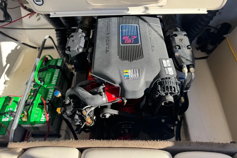 Slide: The Image of 2004 Glastron GX 235 engine compartment with visible 5.7 GXi engine and batteries. - 15