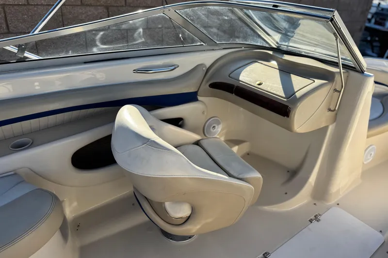 Slide: The Image of 2004 Glastron GX 235 boat interior with white seating and dashboard. - 17