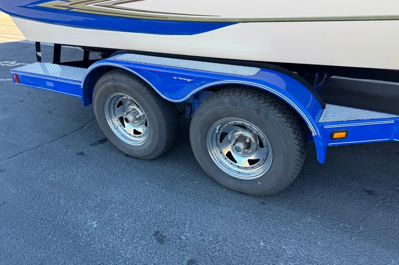 Slide: The Image of Blue trailer with dual wheels for 2004 Glastron GX 235 boat. - 24