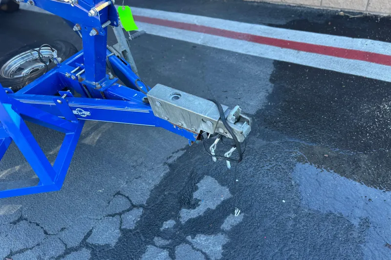 Slide: The Image of Trailer hitch of a 2004 Glastron GX 235 on wet pavement. - 25