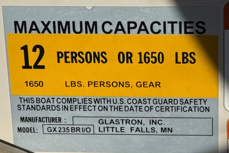 Slide: The Image of 2004 Glastron GX 235 capacity label: 12 persons or 1650 lbs, U.S. Coast Guard compliant. - 26