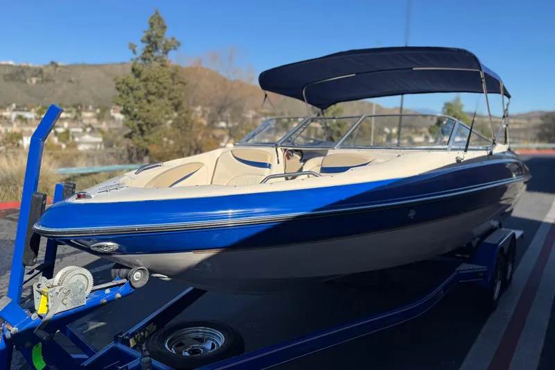 Slide: The Image of 2004 Glastron GX 235 boat with blue and white exterior on a trailer. - 3