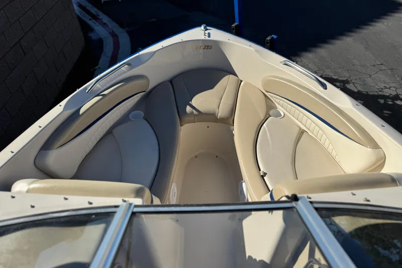 Slide: The Image of 2004 Glastron GX 235 boat interior with beige seating and cup holders. - 8