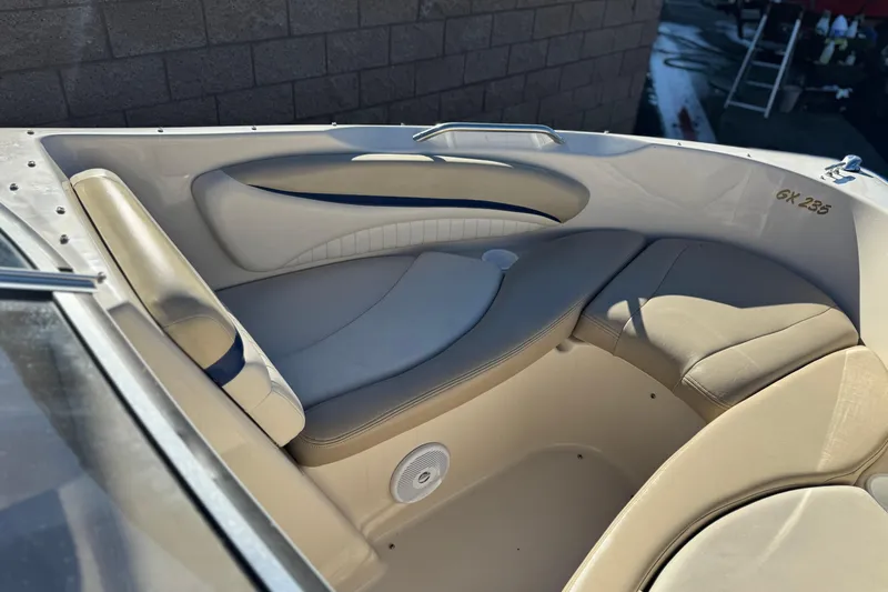Slide: The Image of 2004 Glastron GX 235 boat interior with beige seating and sleek design. - 9