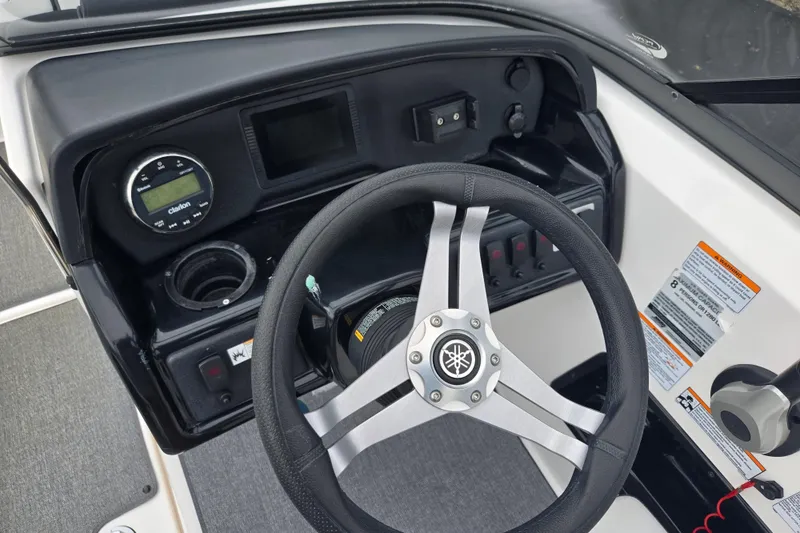 Slide: The Image of 2019 Yamaha Boats AR195 dashboard with steering wheel and control panel. - 13
