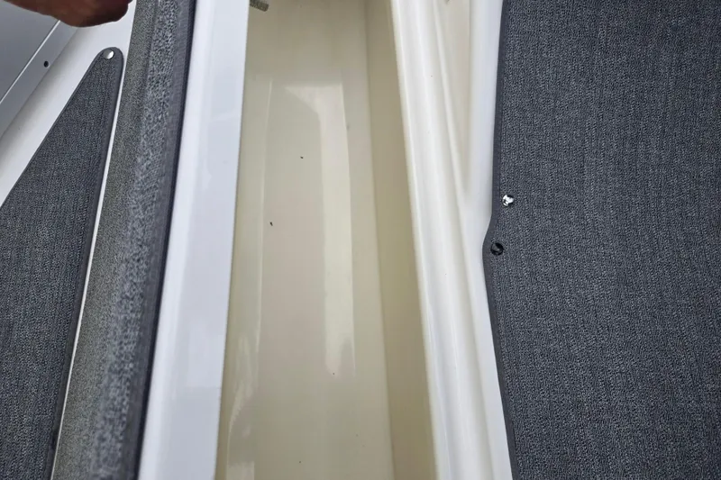 Slide: The Image of Storage compartment of a 2019 Yamaha AR195 boat with gray interior lining. - 15