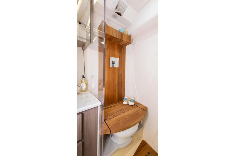 Slide: The Image of Manufacturer Provided Image: 2025 Regal 36 XO yacht bathroom with wooden accents and modern fixtures. - 18