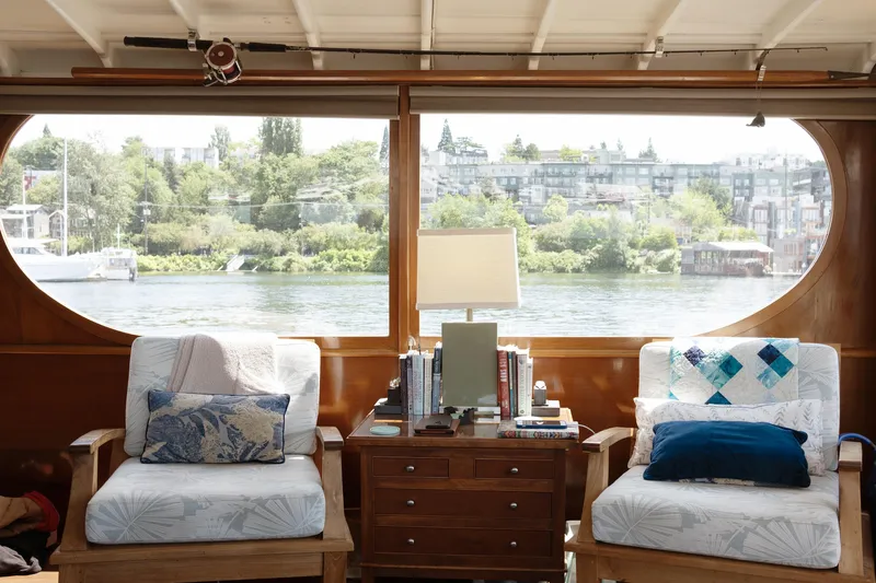 Slide: The Image of Interior of a 1954 Grebe Sedan with cozy seating and river view. - 11