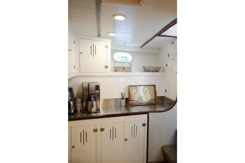 Slide: The Image of Vintage 1954 Grebe Sedan interior with white cabinets and coffee maker. - 16