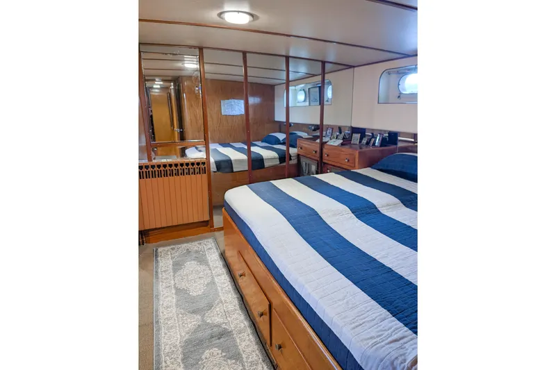 Slide: The Image of Cozy bedroom with striped bedding, wooden decor, and nautical-themed accents on a vintage Grebe Sedan. - 18