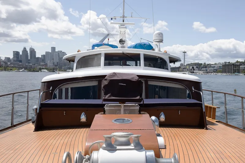 Slide: The Image of Luxurious yacht deck with city skyline in the background, featuring a 1954 Grebe Sedan. - 2