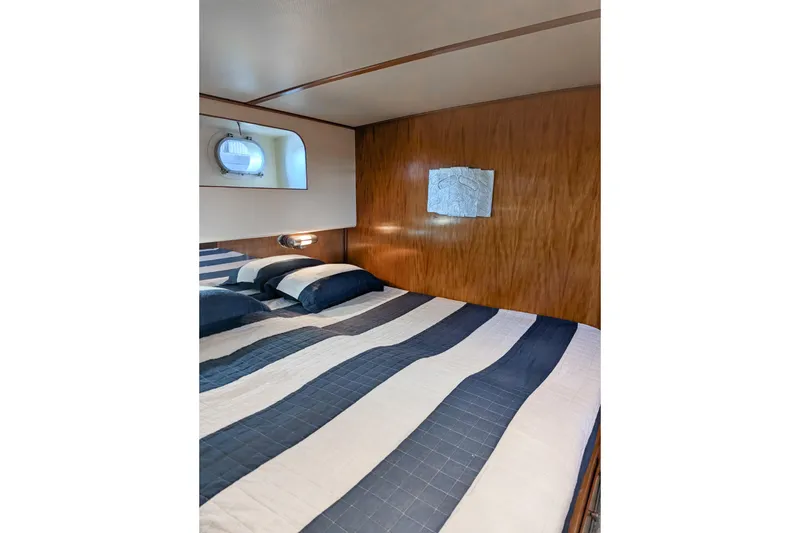 Slide: The Image of Cozy bedroom with striped bedding and wooden walls in a 1954 Grebe Sedan. - 20