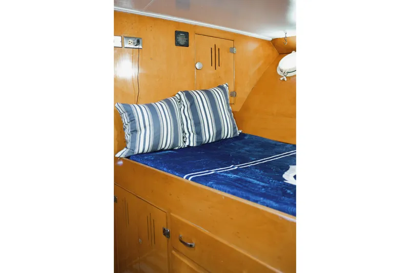 Slide: The Image of 1954 Grebe Sedan interior with blue bedding and striped pillows. - 21