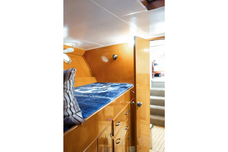 Slide: The Image of 1954 Grebe Sedan interior with wooden cabinetry and cozy bedding. - 22