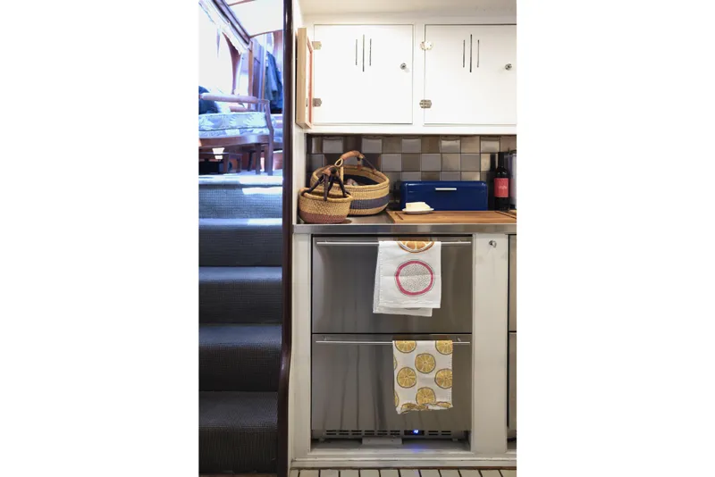 Slide: The Image of Cozy kitchen area with stairs, baskets, and colorful towels in a vintage 1954 Grebe Sedan. - 23