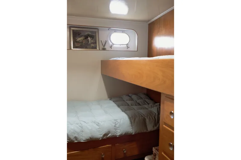 Slide: The Image of Cozy bunk bed setup in a 1954 Grebe Sedan, featuring wooden accents and a small window. - 26