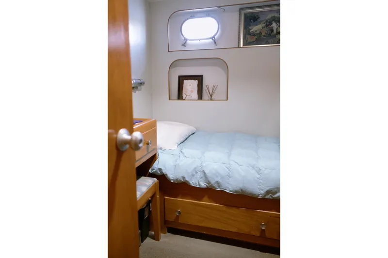 Slide: The Image of Cozy cabin interior with bed, wooden furniture, and porthole window in 1954 Grebe Sedan. - 27