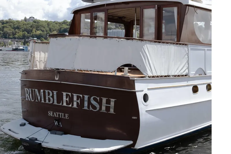 Slide: The Image of Classic boat "Rumblefish" docked in Seattle, featuring elegant wooden design. - 3