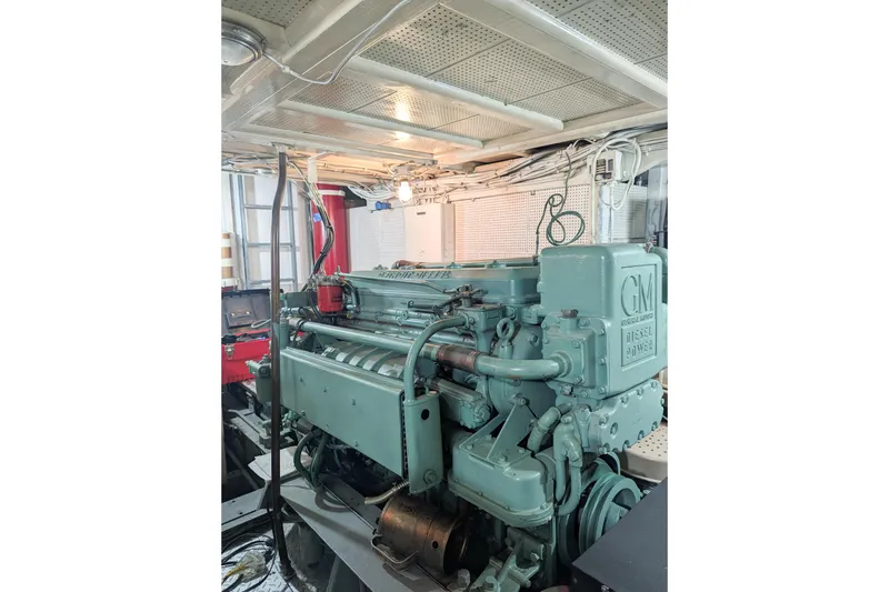 Slide: The Image of 1954 Grebe Sedan engine room featuring a vintage GM diesel engine. - 32