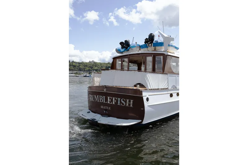 Slide: The Image of 1954 Grebe Sedan boat "Rumblefish" on water in Seattle, WA, under a partly cloudy sky. - 36