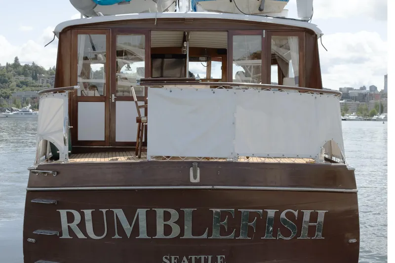 Slide: The Image of Wooden boat named "Rumblefish" docked in Seattle, featuring classic design elements. - 37