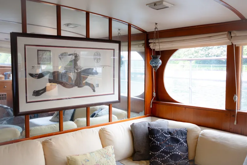 Slide: The Image of Interior of a 1954 Grebe Sedan with framed art and cozy seating area. - 4