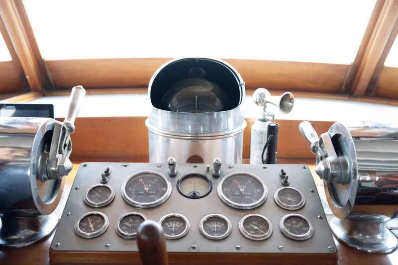 Slide: The Image of Vintage boat control panel with gauges and levers, showcasing nautical instrumentation. - 5