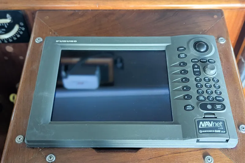 Slide: The Image of Furuno NAVnet VX2 marine navigation system on wooden dashboard. - 8