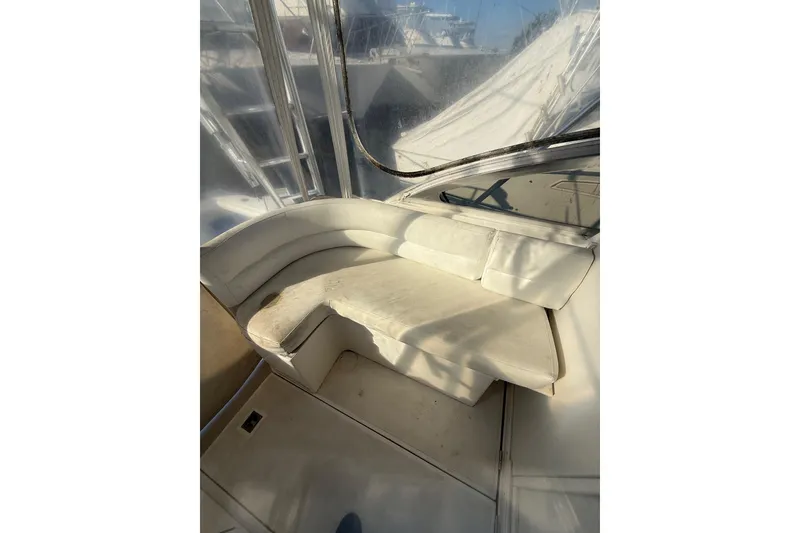 Slide: The Image of Interior seating of 1995 Blackfin 31 Combi boat, featuring white cushioned seats. - 11