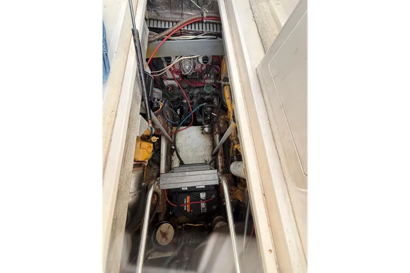 Slide: The Image of Engine compartment of a 1995 Blackfin 31 Combi boat, showcasing mechanical components. - 13