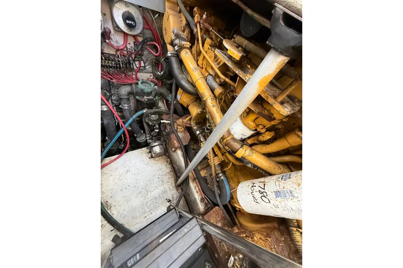 Slide: The Image of Engine compartment of a 1995 Blackfin 31 Combi boat, showing detailed mechanical components. - 14