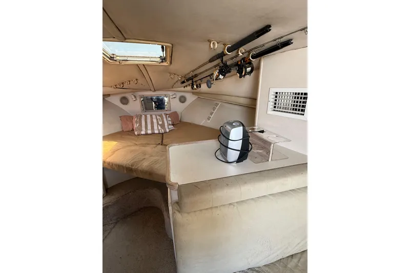 Slide: The Image of Interior of 1995 Blackfin 31 Combi boat with fishing rods and cozy seating area. - 23