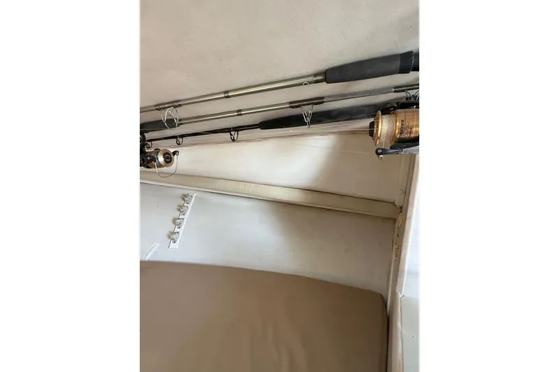 Slide: The Image of Fishing rods stored inside a 1995 Blackfin 31 Combi boat cabin. - 24