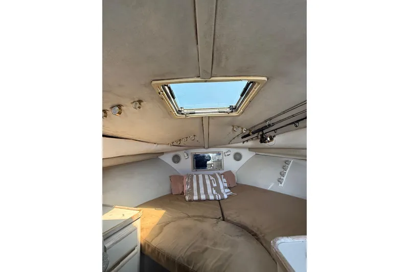 Slide: The Image of Interior cabin of 1995 Blackfin 31 Combi boat with skylight and cozy bedding. - 26
