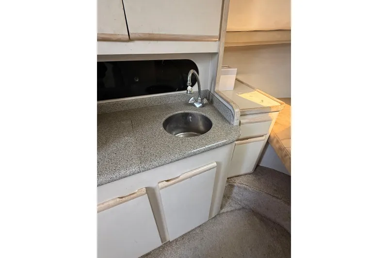 Slide: The Image of Interior of 1995 Blackfin 31 Combi boat featuring a compact kitchenette with sink. - 28