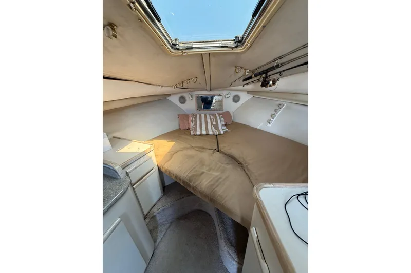 Slide: The Image of 1995 Blackfin 31 Combi cabin interior with bed, storage, and fishing rod holders. - 29
