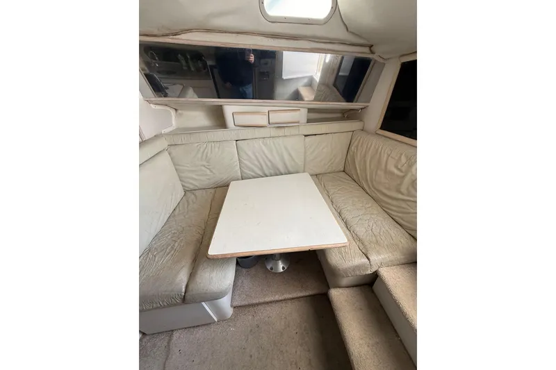 Slide: The Image of Interior of 1995 Blackfin 31 Combi boat with beige seating and table. - 30