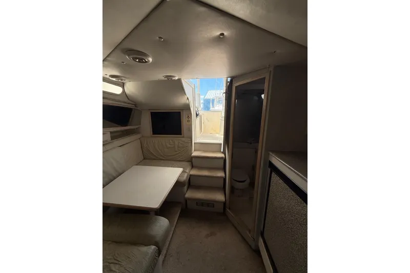 Slide: The Image of Interior of 1995 Blackfin 31 Combi boat with seating, table, and stairs. - 31