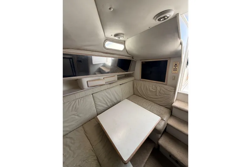 Slide: The Image of Interior of 1995 Blackfin 31 Combi boat with cozy seating and table. - 32