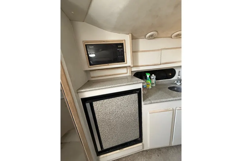 Slide: The Image of 1995 Blackfin 31 Combi boat interior with microwave, fridge, and sink. - 33