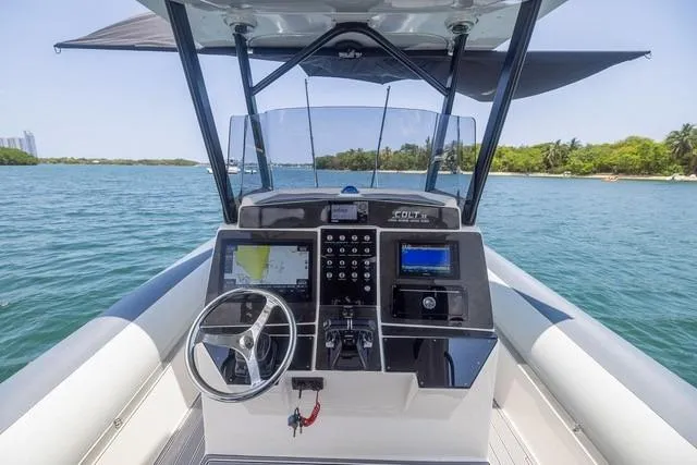 Slide: The Image of 2018 RIB CVL Colt 35 boat docked at marina under blue sky. - 11