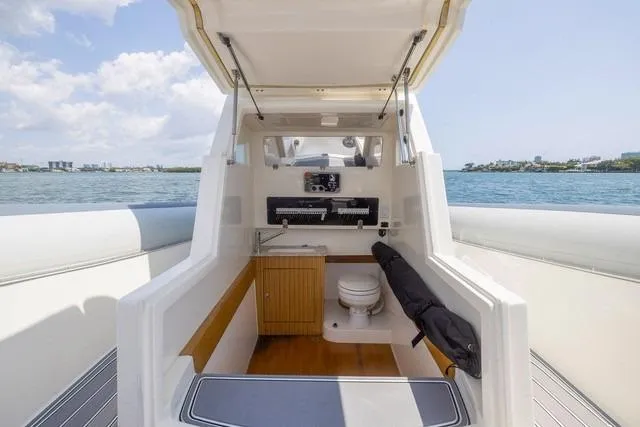 Slide: The Image of 2018 RIB CVL Colt 35 boat docked, featuring sleek design and dual engines. - 12