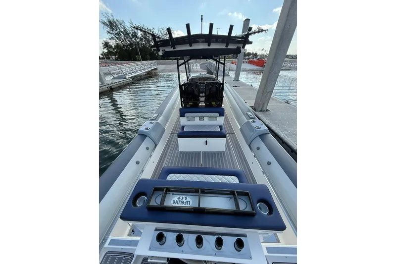 Slide: The Image of 2018 RIB CVL Colt 35 boat docked, featuring sleek design and modern seating arrangement. - 23